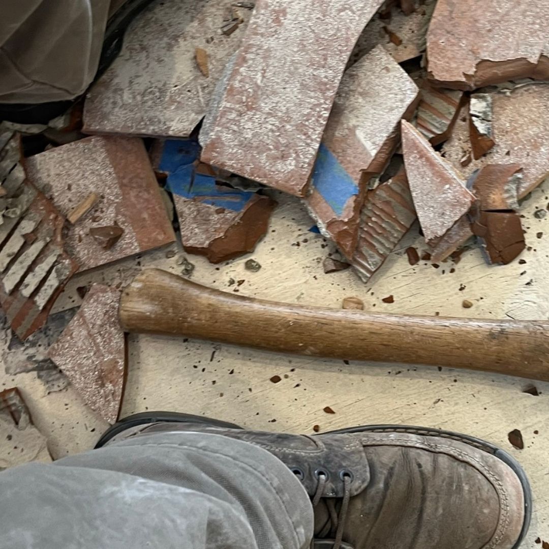 foot next to an axe and rubble